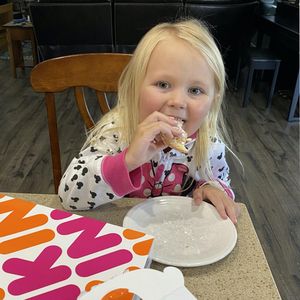 Evelyn devouring a Dunkin Donut from The Donut Fairy